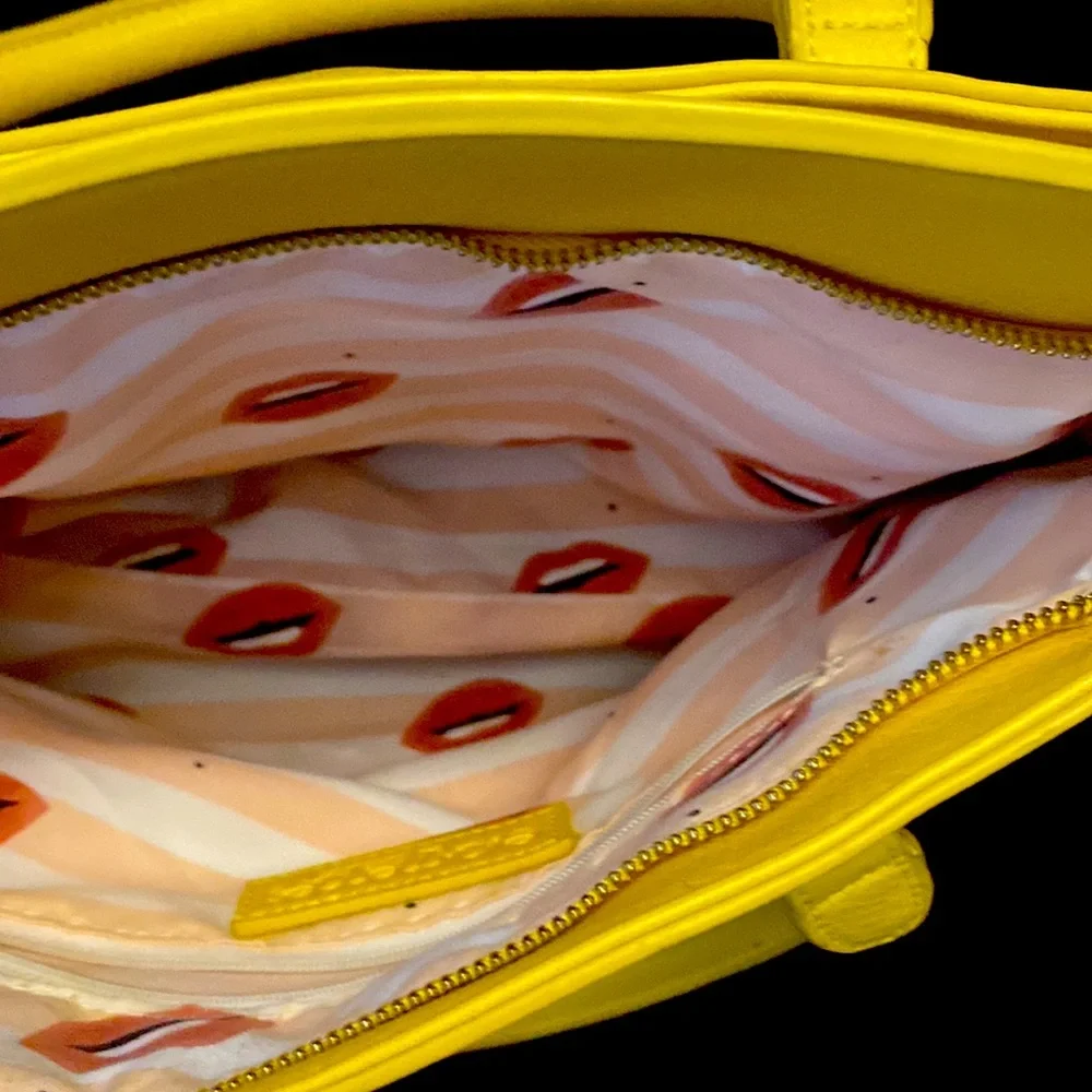 YELLOW EVA MENDES NEW YORK & COMPANY HANDBAG. It has 2 dividers with zippers.